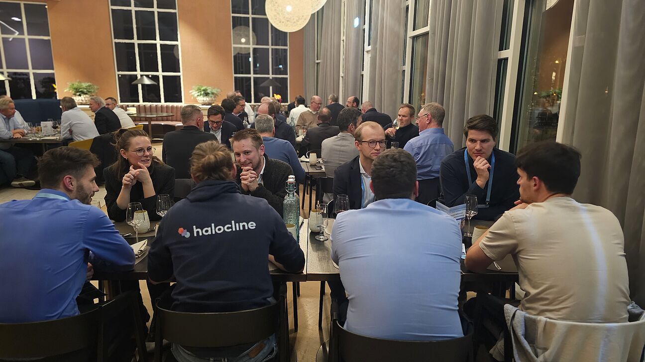 Foto von den Teilnehmern auf der Abendveranstaltung des Fachkongress Fabrikplanung 2025 während sie an den Tischen sitzen und sich austauschen